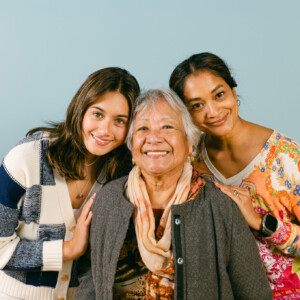 three women posing on a blue background