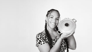 student holding cooking pot