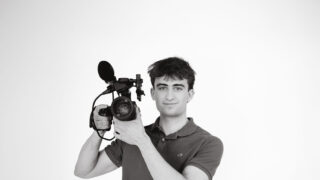 Student holding video camera