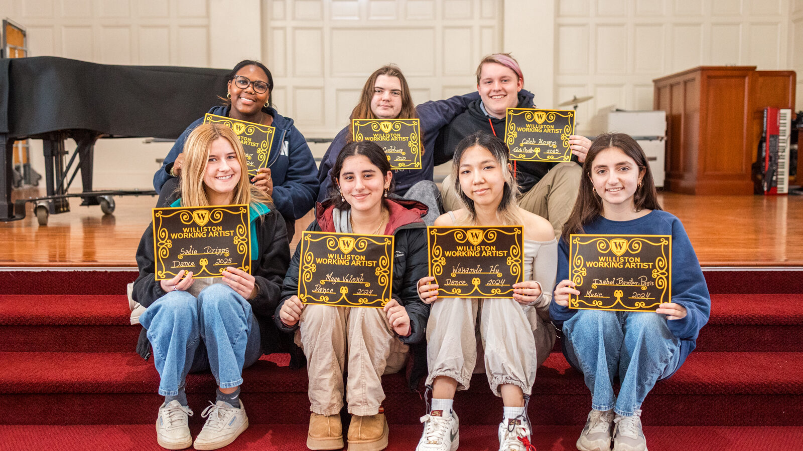 students on stairs posing with certificates