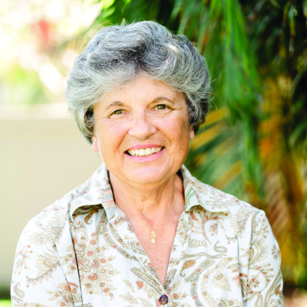 woman on patio with palm trees