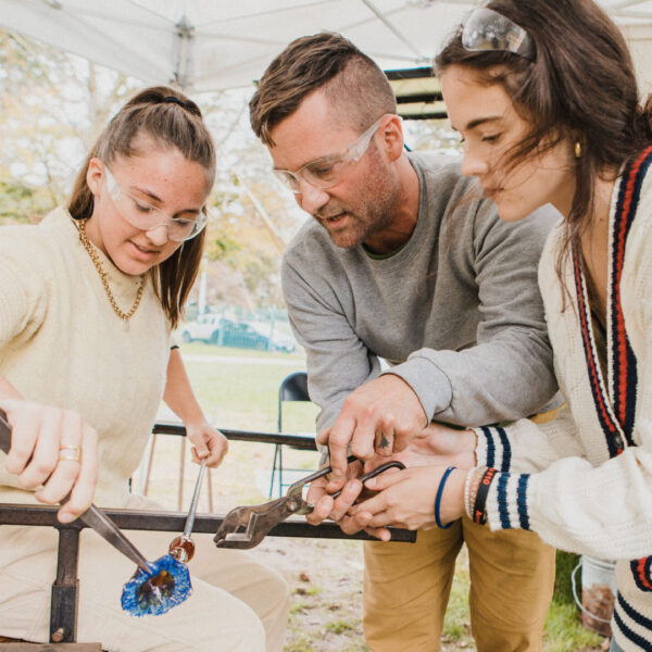 people blowing glass