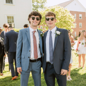 two boys in sunglasses and suits