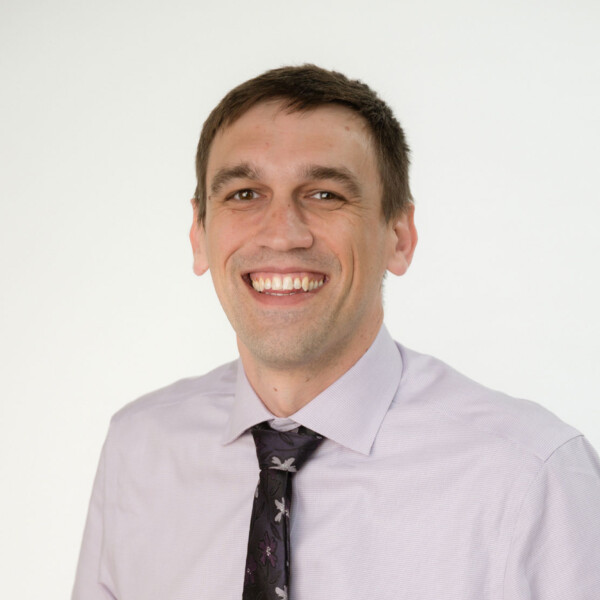 man wearing tie smiling