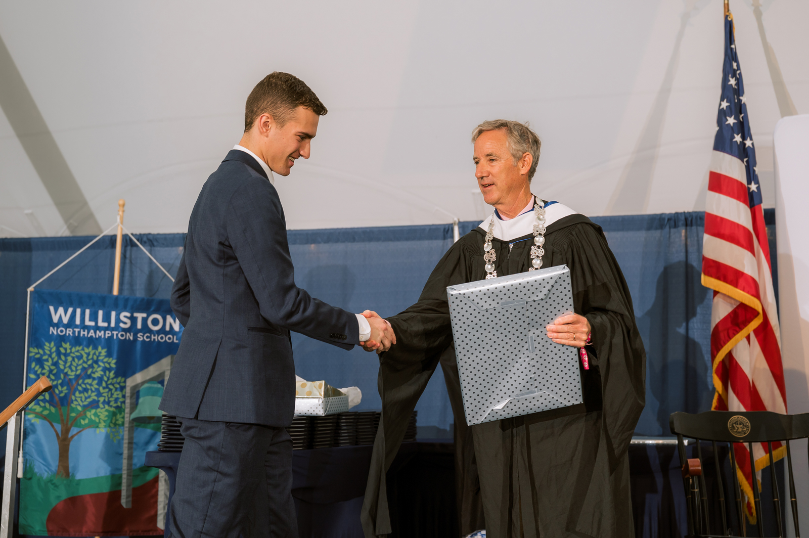 Student shakes hand with Head of School while receiving award