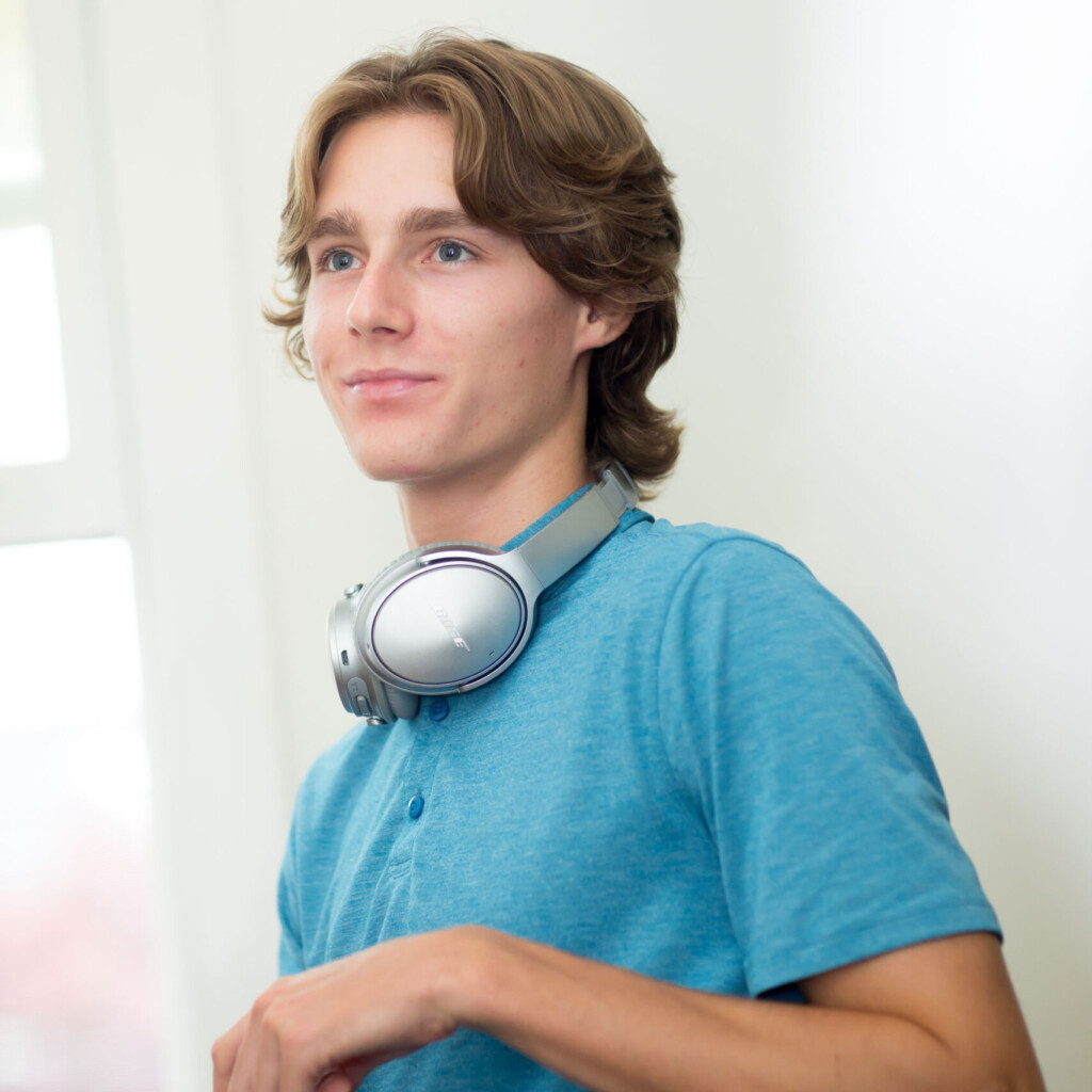 student in blue shirt with headphones