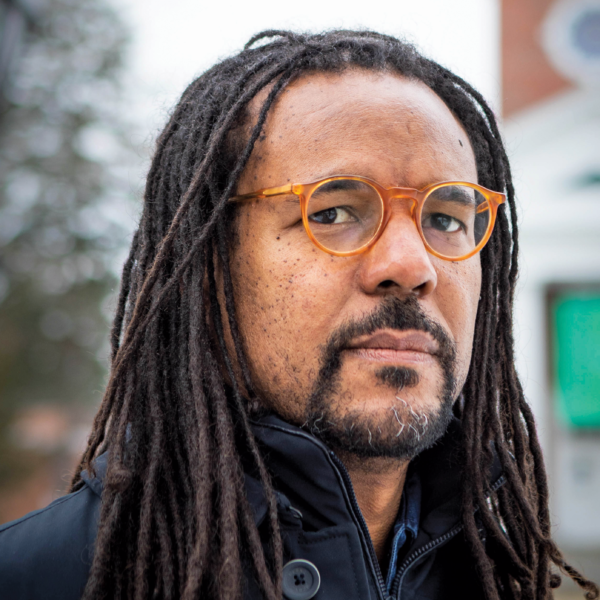 man stands in front of building